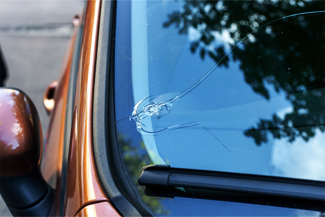 Car with a damaged windshield, which can be repaired with a Way+ glass repair protection plan