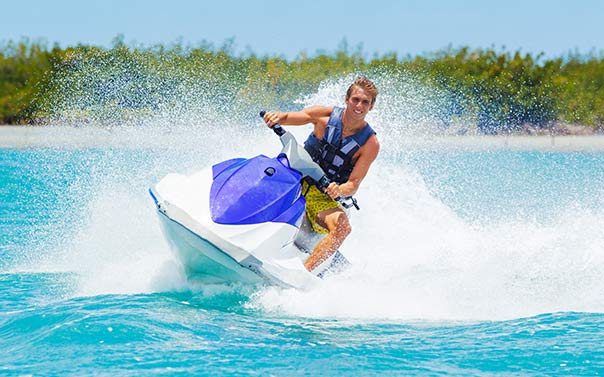 young man on jet ski in summer
